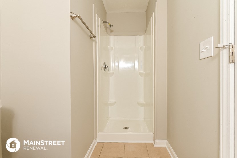 a small bathroom with a shower and a toilet in it