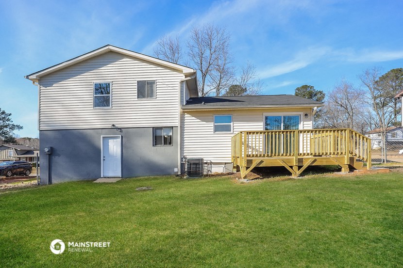 a white house with a porch and a deck