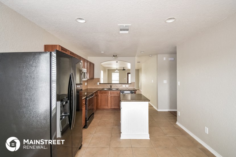 the kitchen has stainless steel appliances and a large island