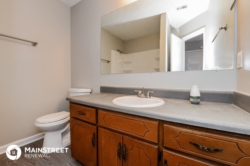a bathroom with a sink and a mirror and a toilet