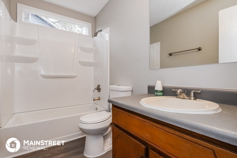 a bathroom with a sink and a toilet and a shower