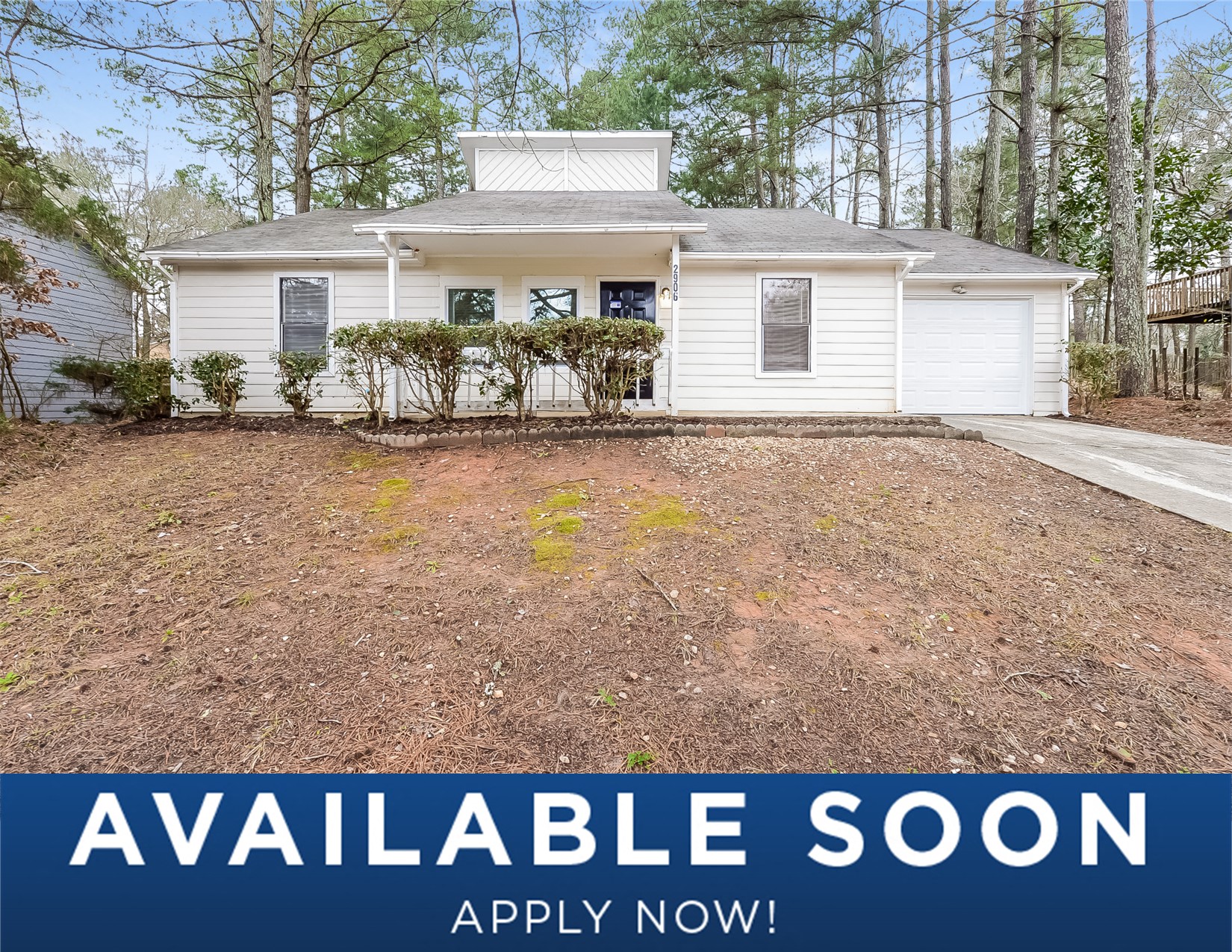 a small white house with a yard in front of it