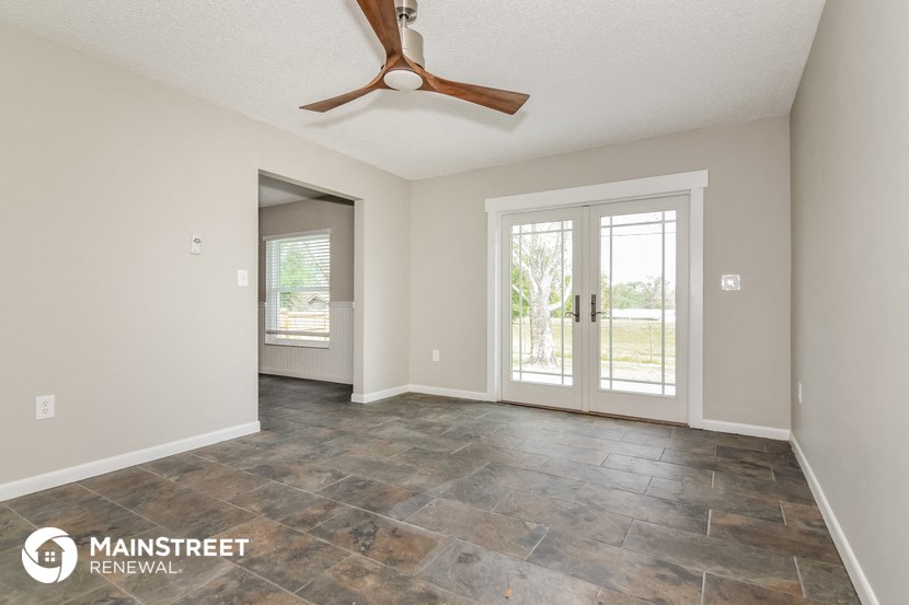 the living room of a house with a ceiling fan