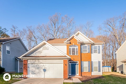 a brick house with a white garage door