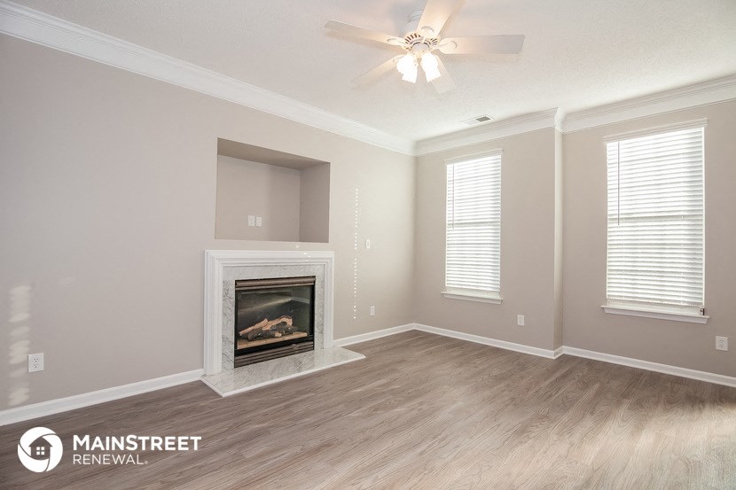 the living room of a new home with a fireplace