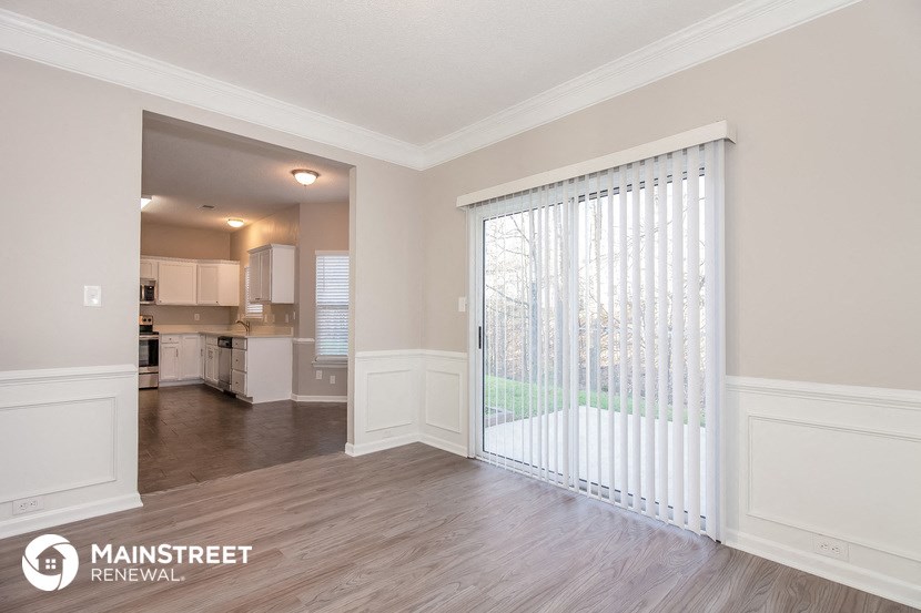 the living room is open to the dining room and kitchen