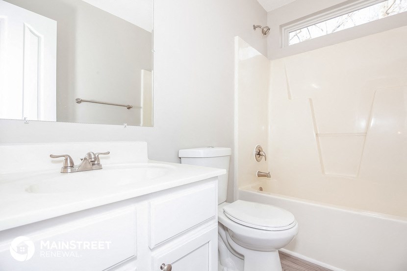 a white bathroom with a sink and a toilet