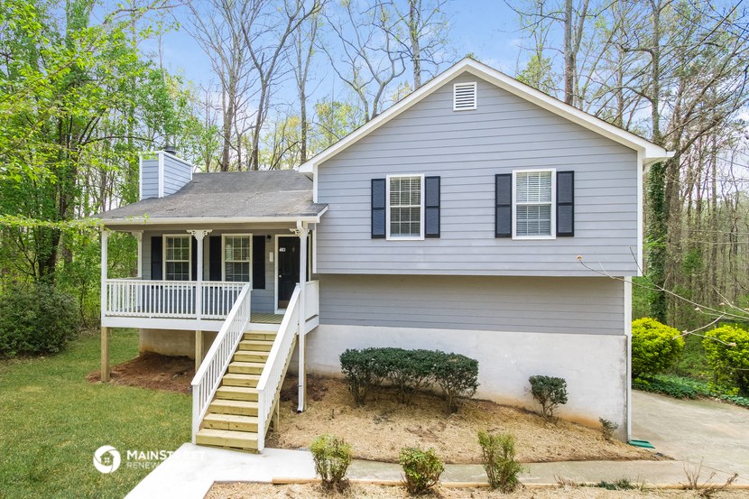a white house with a porch and a white staircase