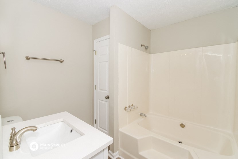 a bathroom with a sink and a tub and a shower