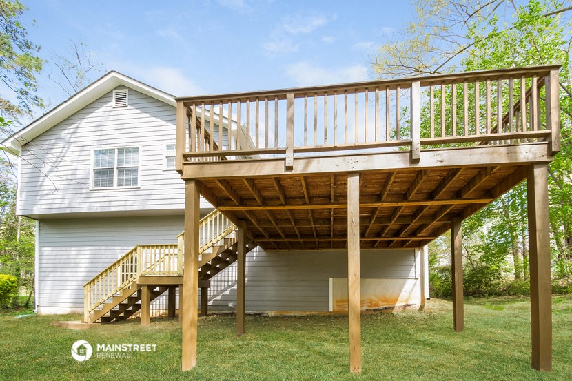 a deck with a roof on top of a house