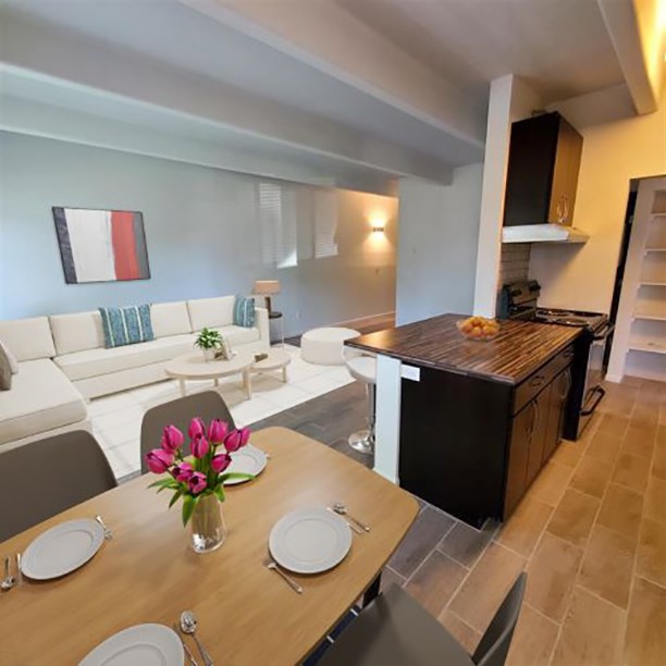 a living room and dining room with a table and chairs