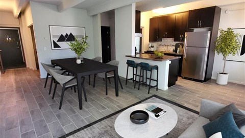 A modern kitchen with a dining table and chairs.