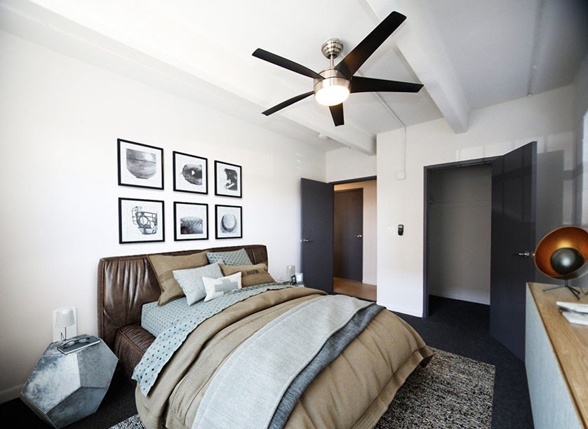 a bedroom with a bed and a ceiling fan