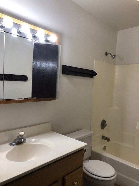 a bathroom with a white sink and a toilet