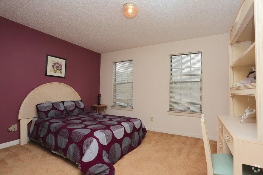 a bedroom with a bed and a closet