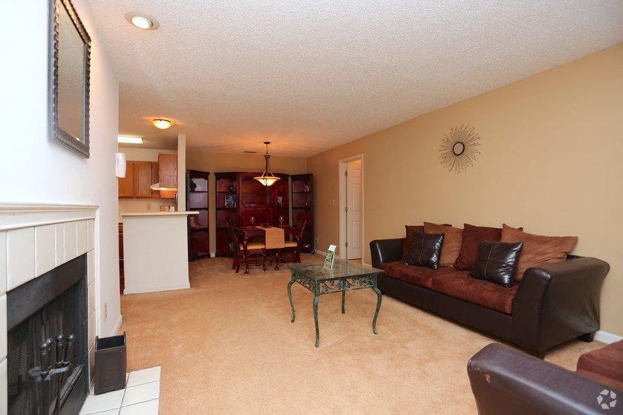 a living room with a couch and a fireplace