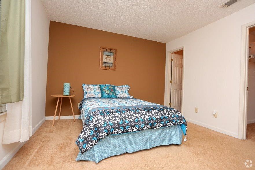 a bedroom with a bed and a table