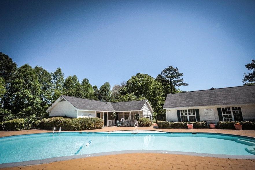 a swimming pool in front of a house