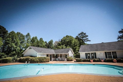 a swimming pool in front of a house