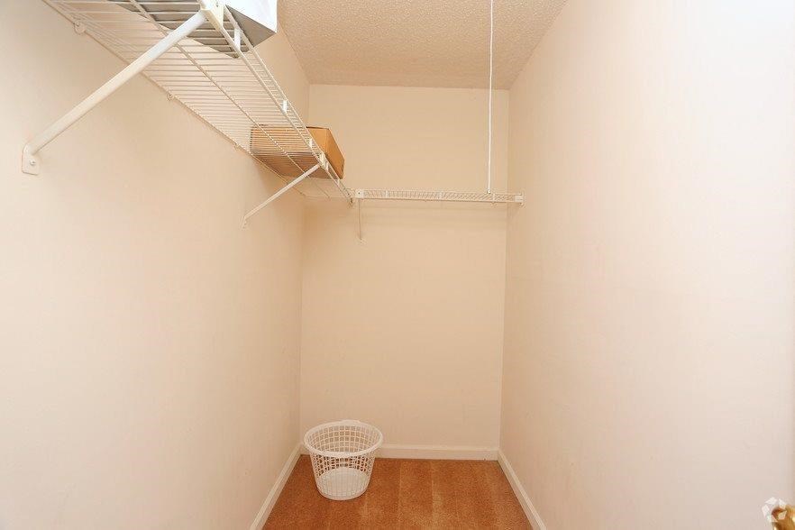 a small closet with a wire rack on the wall