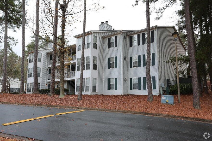 a white apartment building on the side of a road