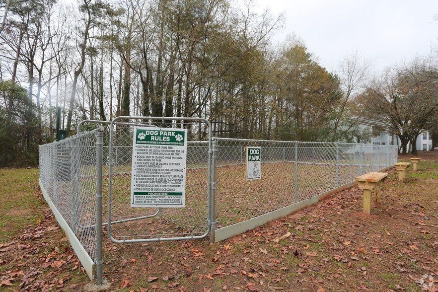 a fence with a sign on it in a park