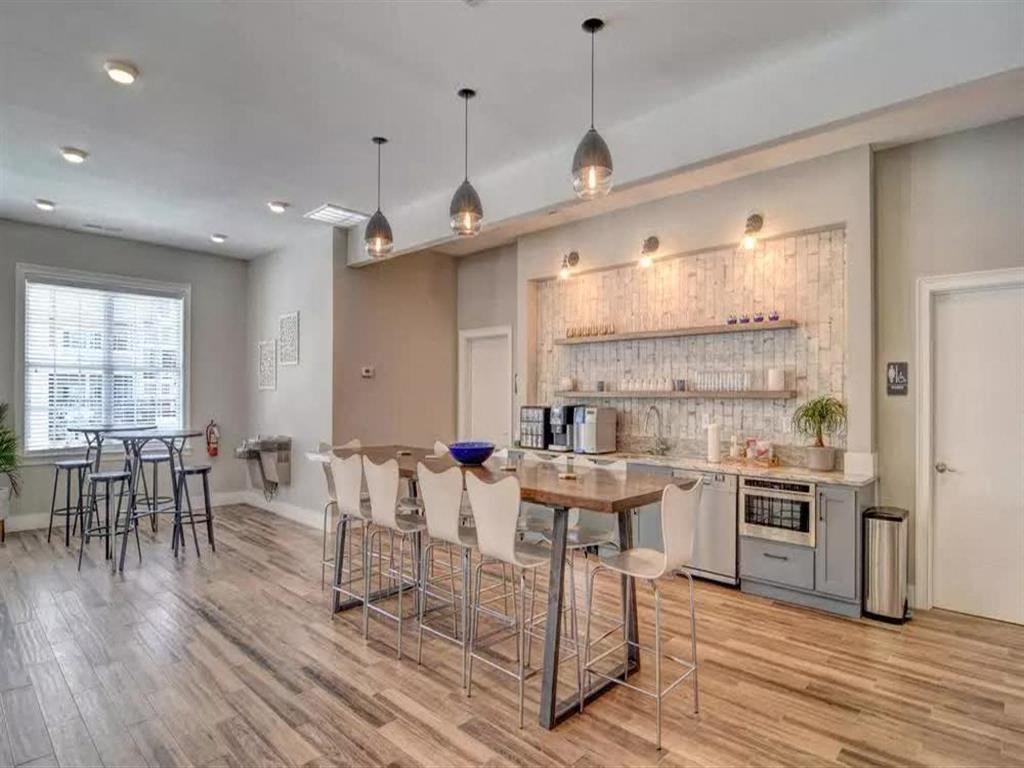 an open kitchen and dining room with a bar and chairs