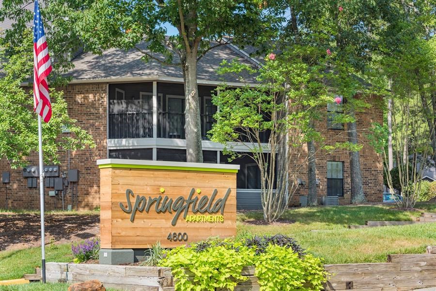 a building with a sign and an flag in front of it