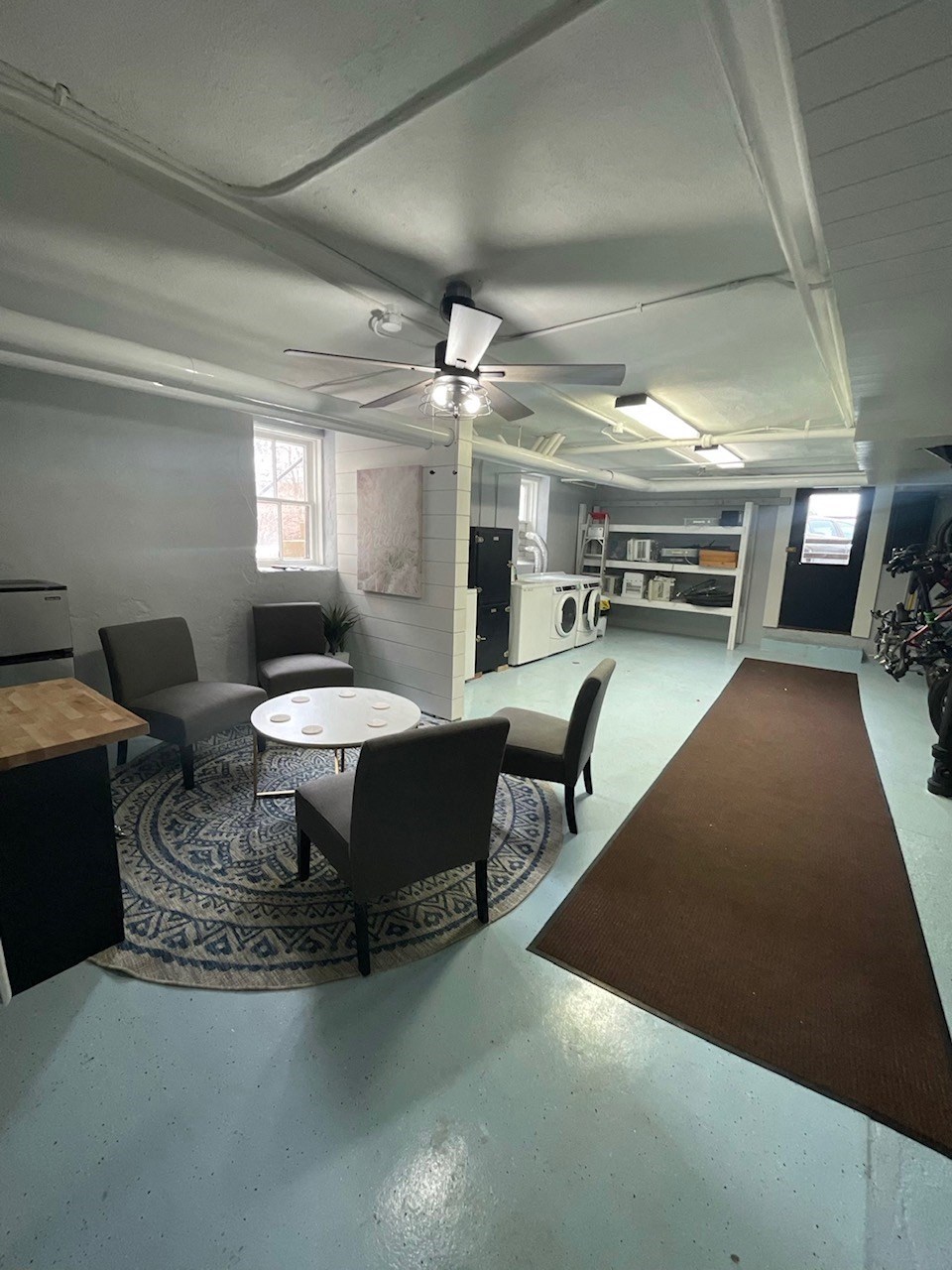 an empty living room with a table and chairs