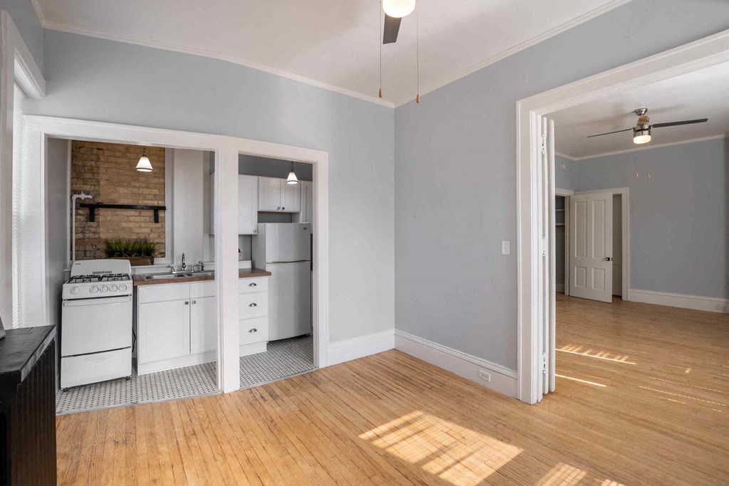 a kitchen and living room with a wood floor