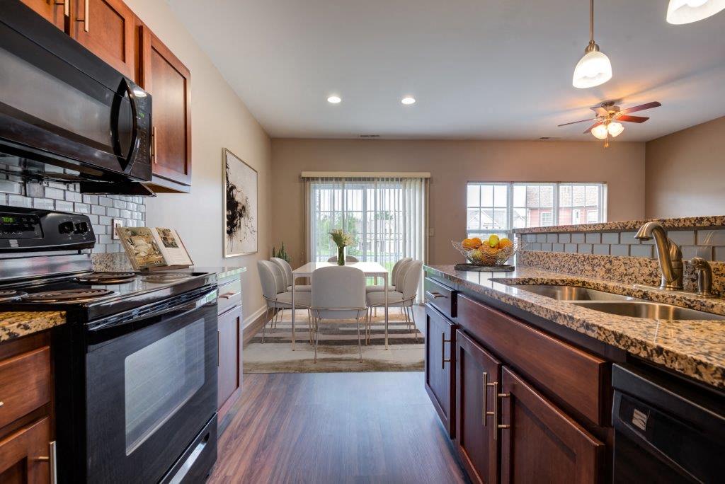 Kitchen with Black Appliances and Granite Countertops with Oak Cabinets