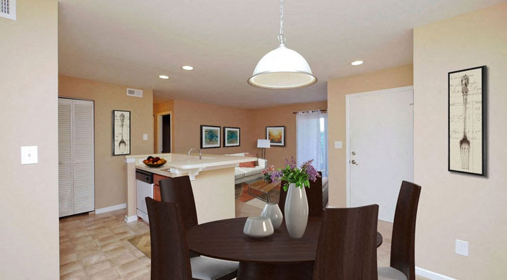 a kitchen and dining room with a table and chairs