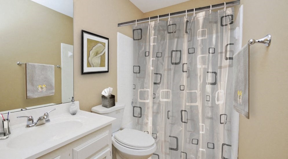 a bathroom with a shower and a sink and a toilet