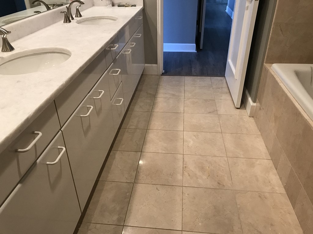a bathroom with two sinks and a door to a closet