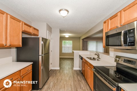 a kitchen with wooden cabinets and stainless steel appliances