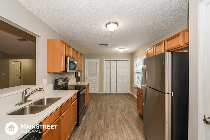 the kitchen of our studio apartment atrium with stainless steel appliances and wooden cabinets