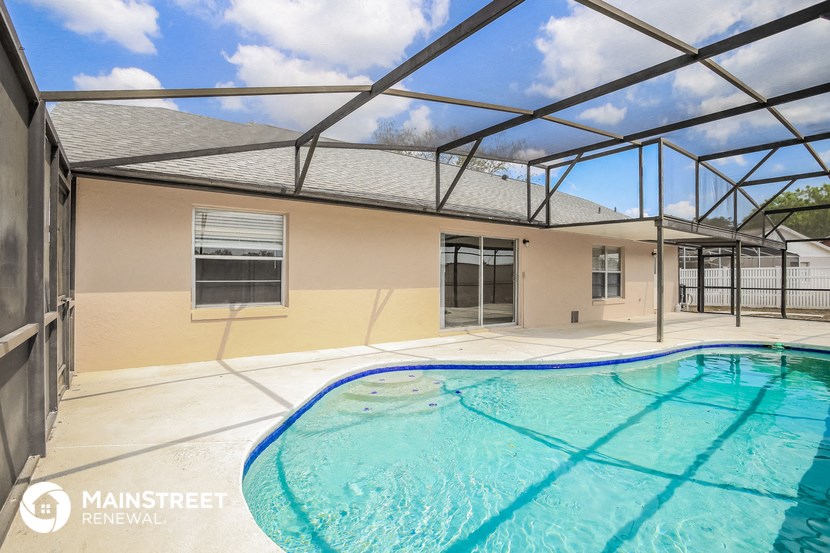 the pool is under an enclosure and next to a house with a swimming pool