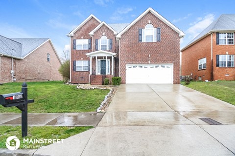 a house with a white garage door in front of a driveway