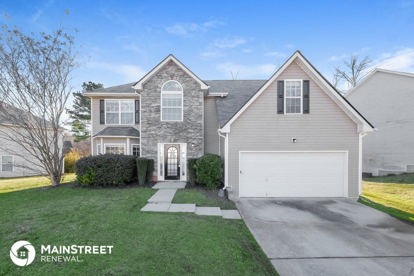 a home with a white house and a white garage door