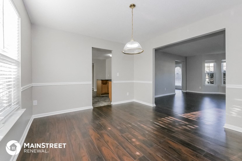 the living room and dining room with hardwood flooring