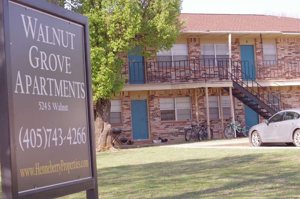 a sign for walnut grove apartments in front of a building