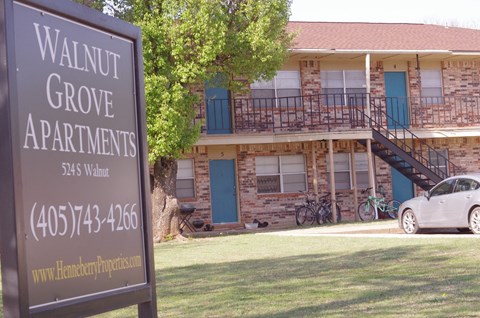a sign for walnut grove apartments in front of a building