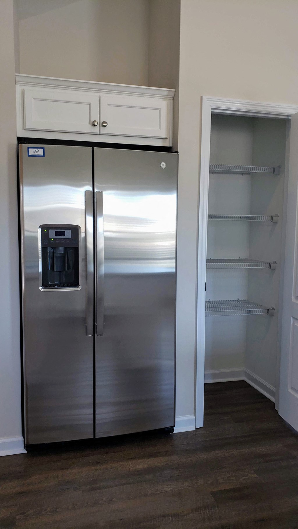 a stainless steel refrigerator freezer sitting inside of a closet
