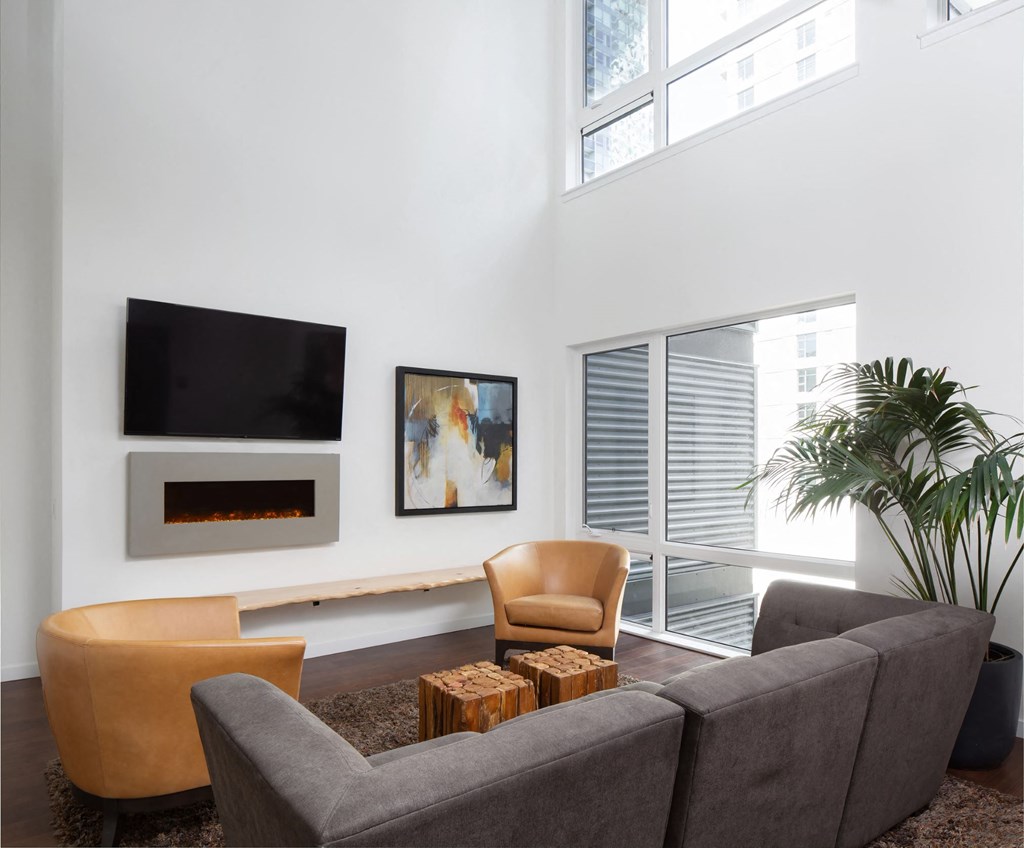 a living room with a couch and chairs and a television