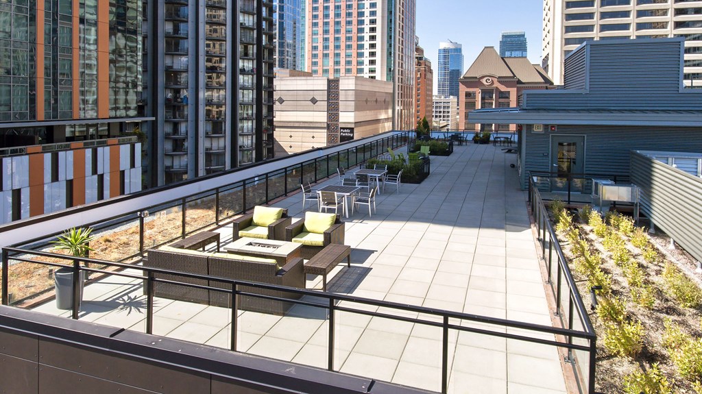 a roof terrace with a view of the city