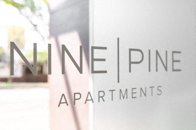 a glass window with the name of some apartments on it