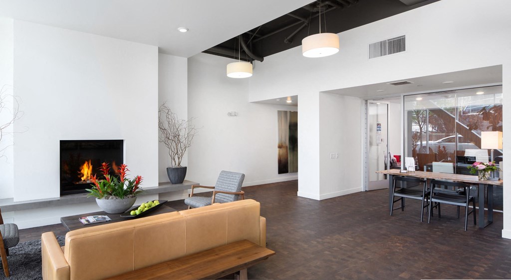 a living room with a fireplace and a table with chairs