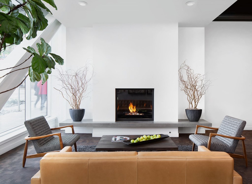 a living room with a fireplace and a couch and chairs
