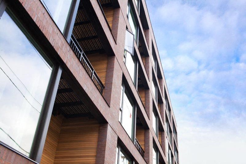 a tall brick building with windows and a blue sky