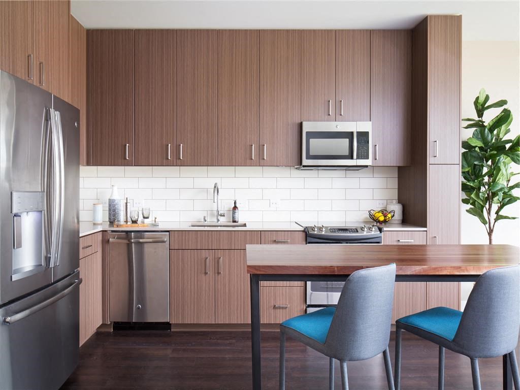 a kitchen with a table and chairs and a refrigerator